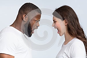 Interracial couple arguing, yelling at each other, having relationship crisis