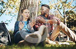 Interracial couple, fight and outdoor with upset young people angry on summer holiday. Conversation, conflict and break