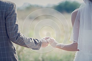 Interracial couple holding hands at wedding