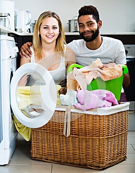 Interracial couple using washing machine