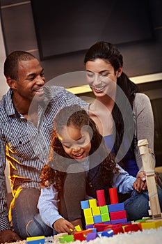 Interracial family at home playing smiling