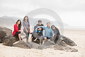 Interracial family of six on beach with special needs child