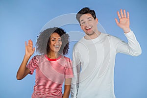 Interracial friendly couple - white man and african woman waving hands - goodbye, chao, adios. Parting, say bye to