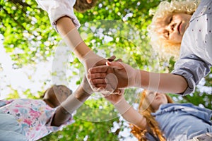 Interracial group of kids, girls and boys playing together at the park in summer day