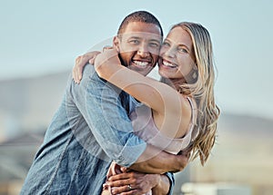 Interracial, happy couple and smile portrait hug of people in summer with happiness or love. Couple, outdoor and smiling