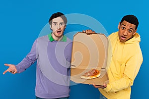 interracial hipsters holding box with pizza