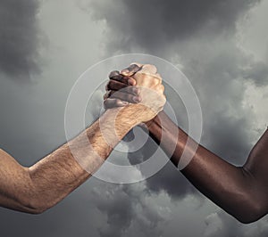 Interracial human hands for friendship - Concept of peace and unity against racism