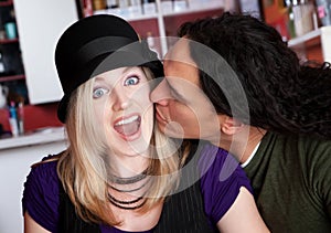 Interracial kiss alone at a cafe