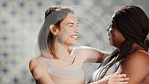 Interracial ladies feeling confident posing for skincare ad