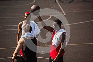 Interracial sportsmen with towels and basketball