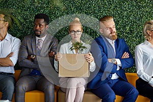 Interracial team of employees unhappy with arrival new emplyee