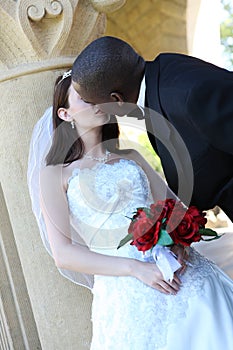 Interracial Wedding Couple Kissing