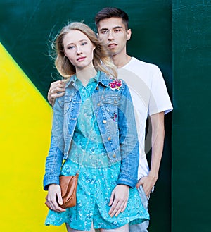 Interracial young couple in love outdoor. Stunning sensual outdoor portrait of young stylish fashion couple posing in summer. Guy