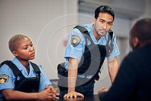 Interrogation, arrest and police team with a suspect for questions as law enforcement officers. Security, crime or