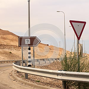 Interrogation mark on road sign and tiangle give way sign
