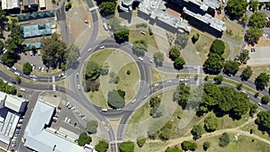 Intersection, circle and traffic from drone on road from drone in industrial, city or neighborhood with cars driving