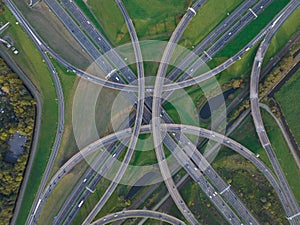 Intersection highway junction crossroad overview top down aerial. Infrastructure road and motor way driving busy street