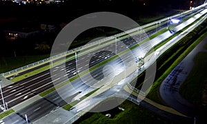 intersection at night from the drone wet road, road lighting wet road, road lighting cars road lanes