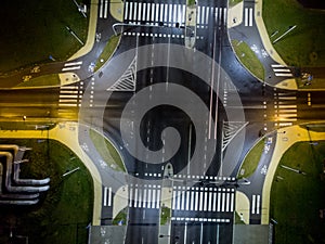 intersection at night from the drone wet road, road lighting wet road, road lighting cars road lanes