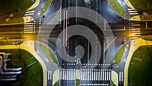 intersection at night from the drone wet road, road lighting wet road, road lighting cars road lanes