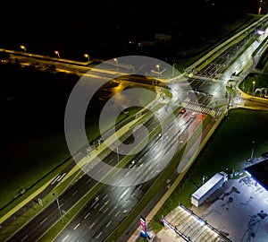 intersection at night from the drone wet road, road lighting wet road, road lighting cars road lanes