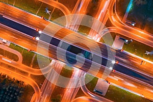 Intersection of two major highways, intersection under a bridge, night aerial top view of street lighting