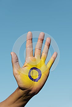 The intersex flag in the palm of the hand