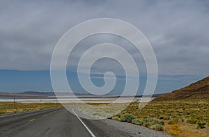 A interstate highway with divider of travelers on a late summer day. US Highway