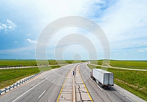 Interstate highway running towards horizon with semi truck