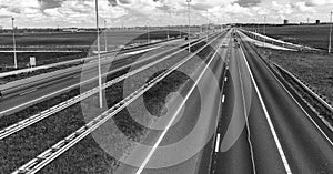 Interstate road in open countryside with blue car speeding up