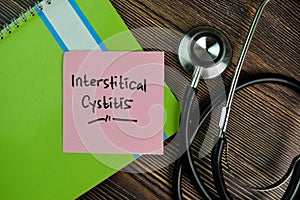 Interstitical Cystitis write on sticky notes isolated on Wooden Table