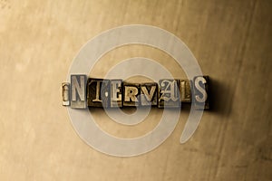 INTERVALS - close-up of grungy vintage typeset word on metal backdrop