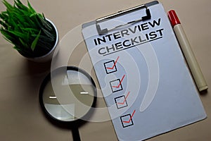 Interview Checlist write on a paperwork isolated on office desk