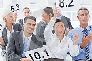 Interview panel holding score cards in office