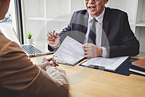 Interviewer or Board reading a resume during a job interview, Employer interviewing a young female job seeker for recruitment