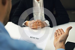 Interviewer and candidate discussion in a job interview reviewing resume photo