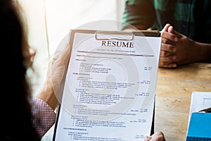 Interviewer reading a resume, Person submits job application, Person describe yourself to interviewer, Close up view of job