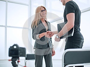 Interviewer welcomes the guest to the Studio