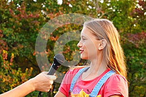 Interviewing girls. Television reporting in the park