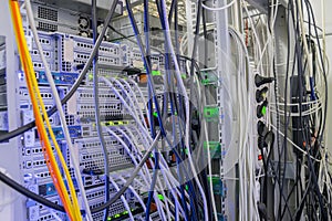 Interweaving a large number of cables in datacenter server room. The rear panel of the rack with servers