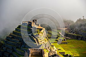 Intihuatana pyramid in a mist with ritual stone on Machu Picchu archeological site, Cusco, Peru, South America