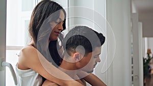 Intimate lovers embrace together morning apartment closeup. Woman looking camera