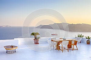 Intimate Romantic Places. Open Air Terrace Restaurant in Beautiful Oia Village on Santorini Island in Greece in Front of Volcanic