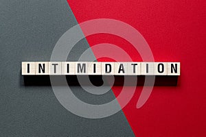 Intimidation - word concept on cubes