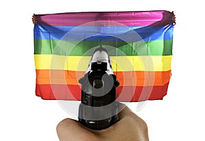 Intolerance violent representation of terrorist attack with hand pointing gun on proud gay holding flag