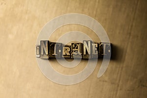 INTRANET - close-up of grungy vintage typeset word on metal backdrop