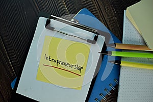 Intrapreneurship write on sticky notes. Isolated on Wooden Table