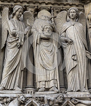 Intricate carvings of Catholic saints on the exterior walls of Notre Dame Cathedral, Paris, France.