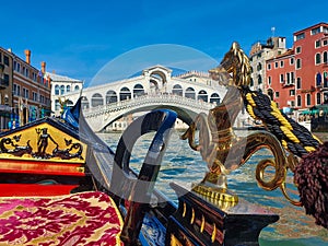 Intricate details on brass gondola horse in venice grand canal in front of rialto bridge