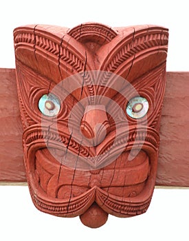 Maori design head carved in wood with paua shell eyes